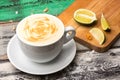 ÃÂ¡appuccino in a white cup with lime slices